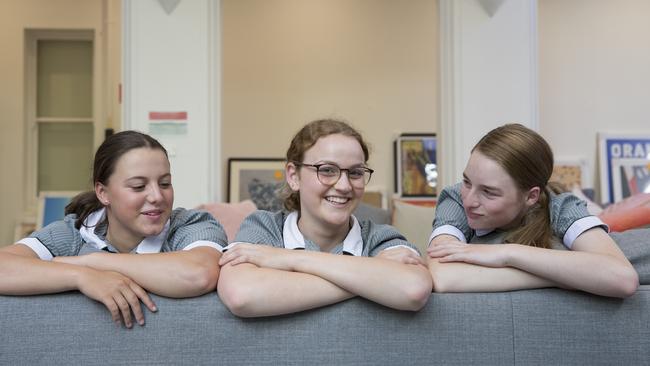 MLC boarder Abbey Bailey (centre) in the Kew boarding house with fellow students.