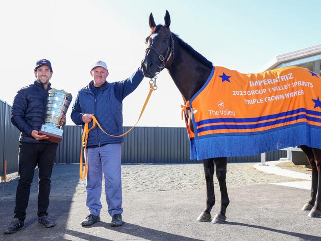 Assistant trainer Ben Gleeson, Te Akau head trainer Mark Walker and champion sprinter Imperatriz with the Triple Crown trophy. Picture : George Sal