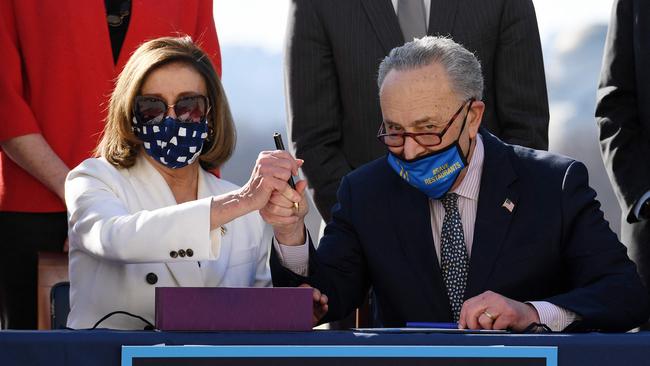 Speaker of the House Nancy Pelosi and Senate majority leader Chuck Schumer, both Democrats, sign the American Rescue Plan Act on Thursday. Picture: AFP