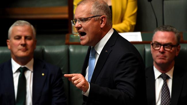 Prime Minister Scott Morrison (centre) speaks at the despatch box alongside Deputy Prime Minister Michael McCormack (rear left) and Minister for Defence Christopher PyneÊ(rear right) Question Time in the House of Representatives, at Parliament House, Canberra, Tuesday, 2 April 2019. (AAP Image/Sam Mooy) NO ARCHIVING