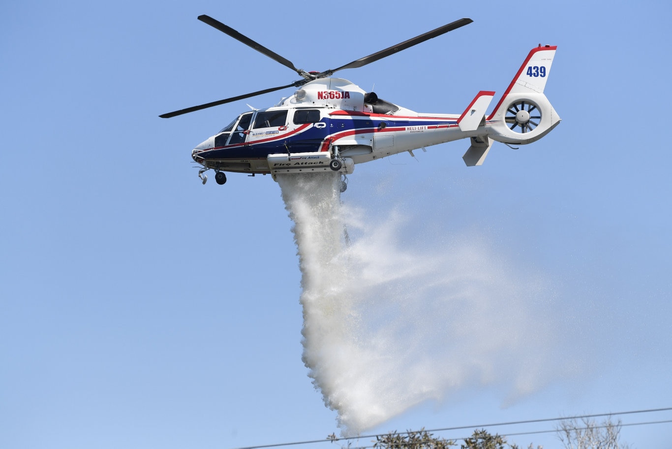 Helicopters dump water on the fire near Peregian. Picture: Warren Lynam