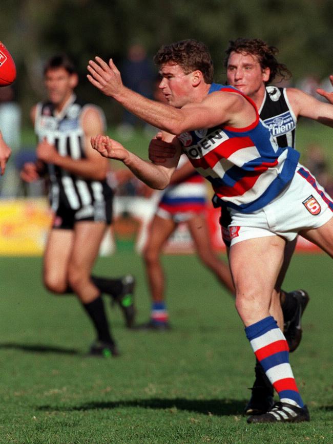 Craig Cotter gets a handball away from Port’s David Brown in 1998.