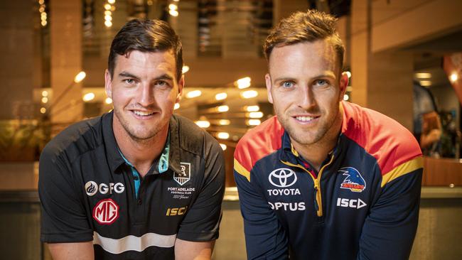 Port Adelaide’s Tom Rockliff and Adelaide’s Brodie Smith want to play this weekend – as long as it’s safe. Picture: AAP/Mike Burton.