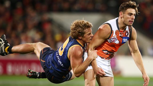 Pressure ... Rory Sloane tackles GWS star Tom Scully, who drops the ball. Picture: Morne de Klerk (Getty Images)