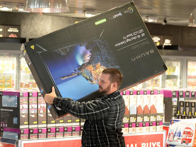 PERTH NOW - Grand opening of Aldi Kwinana, one of four stores opening today. Photo by Daniel Wilkins. PICTURED- A customer gets ready to purchase one of the hottest Aldi Special Buys