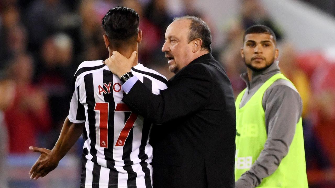 Rafael Benitez restrains Ayoze Perez after the final whistle.