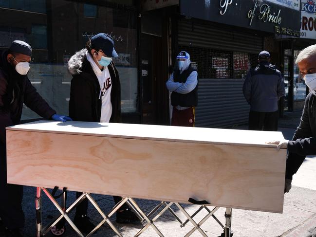 A coffin is taken to a busy Brooklyn funeral home in New York. Picture: AFP.