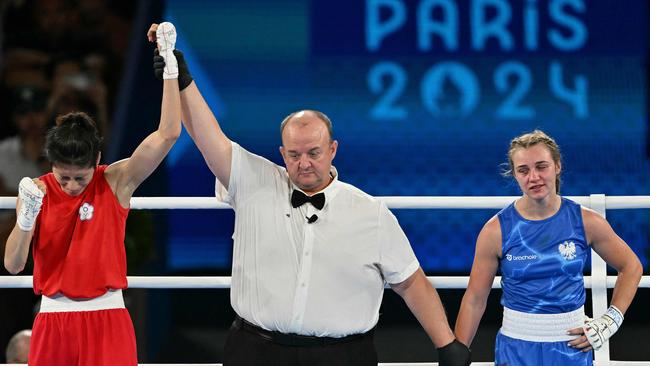 Taiwan's Lin Yu-ting reacts after beating Poland's Julia Szeremeta (Blue) in the women's 57kg final. (Photo by MOHD RASFAN / AFP)