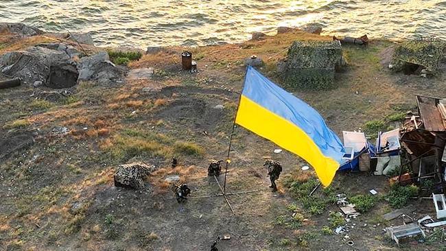 This handout picture taken and released by State Border Guard Service of Ukraine on July 7, 2022 shows the Ukrainian flag set on Bile village on Snake Island in the Black Sea. Picture: AFP.