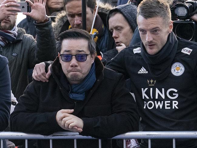 LEICESTER, ENGLAND - OCTOBER 29: Aiyawatt Srivaddhanaprabha, son of the late Leicester City owner Vichai Srivaddhanaprabha, stands with Jamie Vardy (R) as they pay their respects at the sea of tributes to the victims of the crash at Leicester City Football Club's King Power Stadium on October 28, 2018 in Leicester, England. The owner of Leicester City Football Club, Vichai Srivaddhanaprabha, was among the five people who died in the helicopter crash on Saturday evening after the club's game against  West Ham. (Photo by Christopher Furlong/Getty Images) ***BESTPIX***