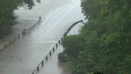 The flooded Bruce Highway at the Seymour River Bridge north of Ingham on Wednesday morning. The notoriously flood-prone highway remains severed to all traffic. Picture: Supplied