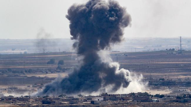 ‘We have American forces likely caught between two advancing armies and it’s a very untenable situation’: Turkish artillery bombards the Syrian border town of Ras al-Ain on Sunday. Picture: Getty Images