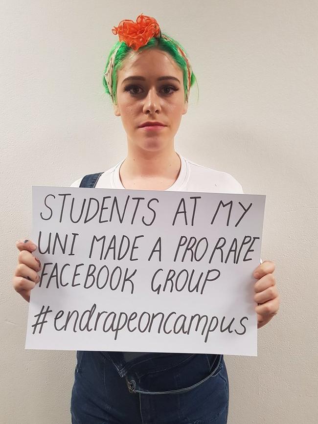 University students pose with signs in support of the recent End Rape on Campus campaign.