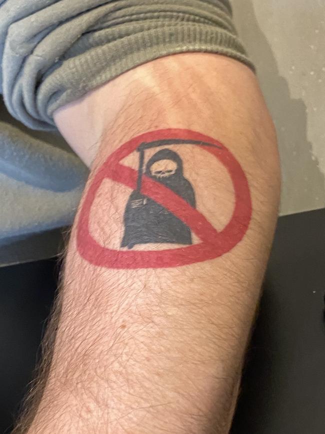 Marc Ryan’s tattoo, a grim reaper with a stop sign.