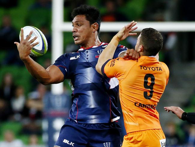 Melbourne Rebels V Cheetahs at AAMI Park, Rebels Lopeti Timani unloads a pass as Cheetahs Shaun Venter holds on. 22nd April 2016. Picture: Colleen Petch.