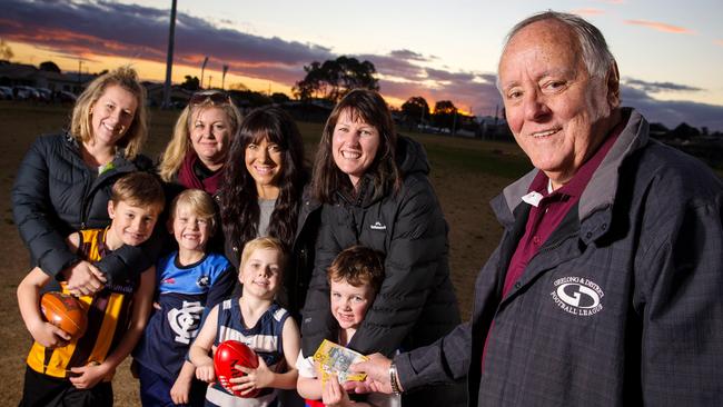 League chief Neville Whitley with footy families happy to see the extra cash. Picture: Mark Stewart