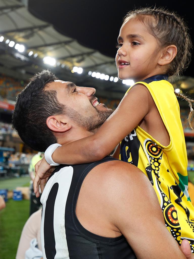 Marlion Pickett celebrates Richmond’s 2020 Grand Final win with his daughter.