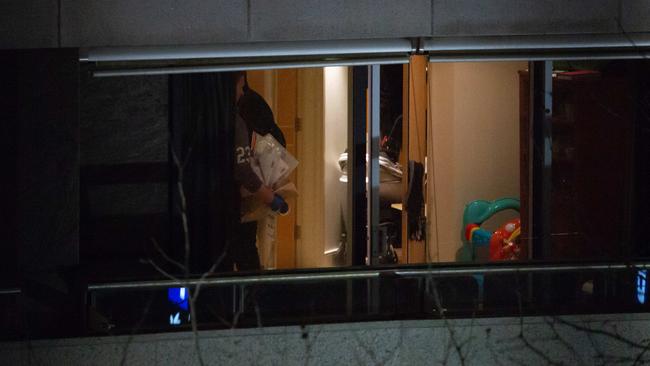 Police search an apartment at the Circular Quay Toaster on Friday night.