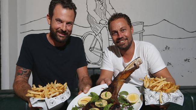 Best of the Gold Coast steak winners Harry's Steak Bistro at Burleigh Heads. Adam Haralampou and Peter Tayler holding a Tomahawk steak. Picture Glenn Hampson