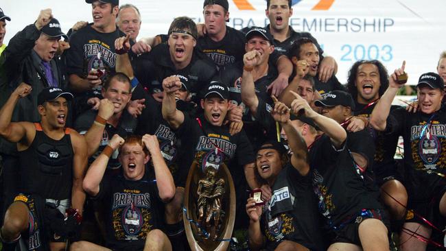 Panthers players celebrate their 2003 NRL grand final triumph.