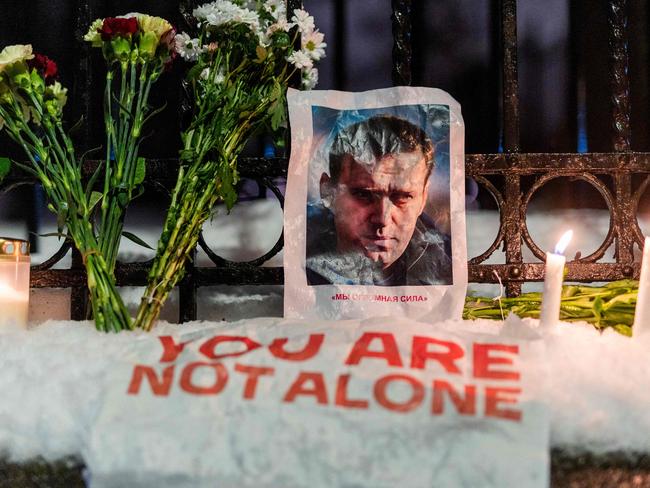 A portrait of Russian opposition leader Alexei Navalny and flowers are pictured during a rally in front of the Russian embassy in Oslo, Norway. Picture: AFP