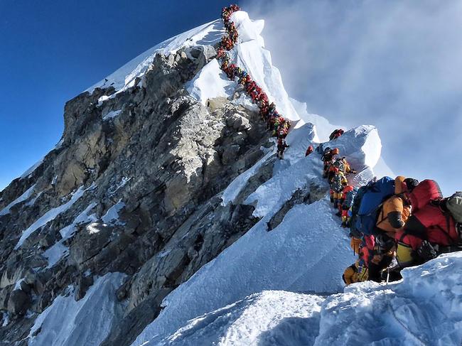 REVALIDATING - MANDATORY CREDIT REQUIRED: “@nimsdai Project Possible” This handout photo taken on May 22, 2019 and released by @nimsdai Project Possible shows heavy traffic of mountain climbers lining up to stand at the summit of Mount Everest. - Three more climbers have died on Everest, expedition organisers and officials said on May 24, taking the toll from a deadly week on the overcrowded world's highest peak to seven. (Photo by Handout / @nimsdai Project Possible / AFP) / RESTRICTED TO EDITORIAL USE - MANDATORY CREDIT "AFP PHOTO / @NIMSDAI PROJECT POSSIBLE" - NO MARKETING NO ADVERTISING CAMPAIGNS - DISTRIBUTED AS A SERVICE TO CLIENTS == NO ARCHIVE