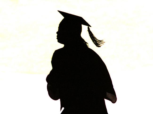 A late arrival makes her way quickly through the parking area under Ohio University's Convocation/Center  Jun 12, 1999.    (AP photo/Bill/Graham) silhouette education student graduate gown mortar board o/seas usa generic