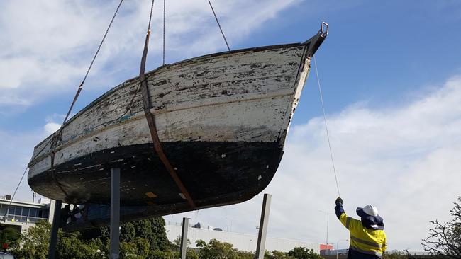 A boat is hauled from the water as part of the War on Wrecks program. Picture: QLD Government