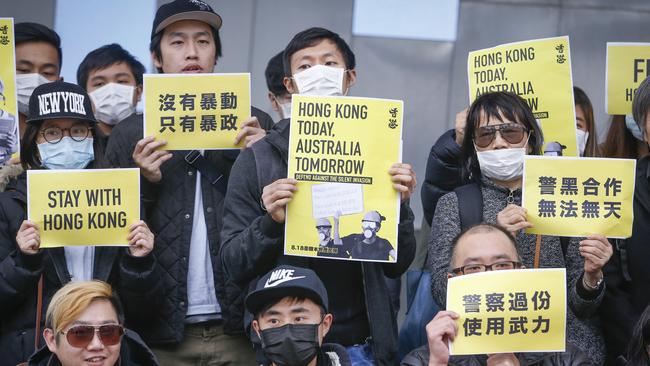 Protesters at Federation Square held sign, one which read “Hong Kong today, Australia tomorrow: defend against the silent invasion”. Picture: Wayne Taylor.