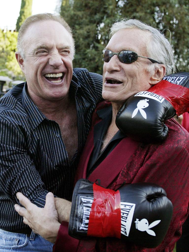 <p>James Caan and Hugh Hefner have a laugh during Fight Night at the Playboy Mansion on July 15, 2003 in Bel Air, California. Picture: Getty</p>