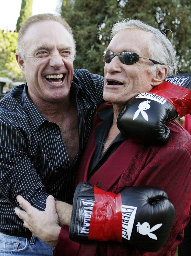 James Caan and Hugh Hefner have a laugh during Fight Night at the Playboy Mansion on July 15, 2003 in Bel Air, California. Picture: Getty