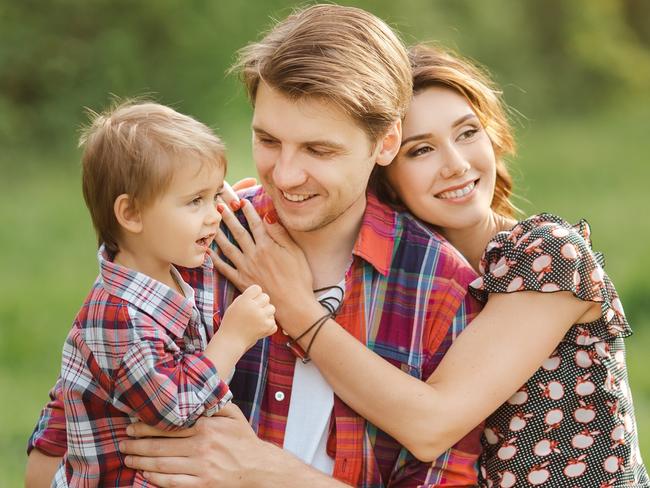 Happy Family on the nature. Mother father and son in casual clothes, sit on a fence, rural look , outdoors; life insurance generic happy family