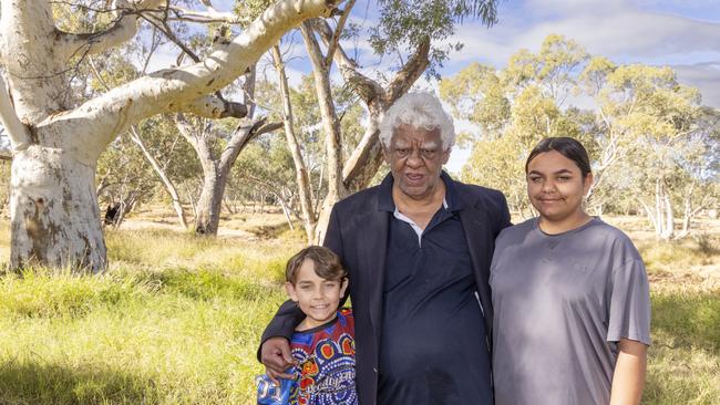 Children’s Ground chair William Tilmouth in Alice Springs, with his grandson Kenny on the left and granddaughter Anthea on the right. Picture: Grenville Turner