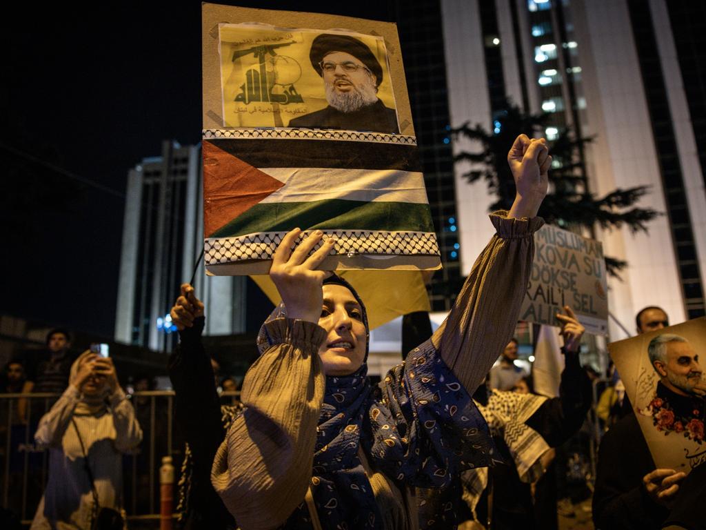 A woman holds a poster of fallen Hezbollah leader Hassan Nasrallah in front of the Israeli Consulate during a solidarity march and protest in Istanbul, Turkey. Picture: Getty Images.