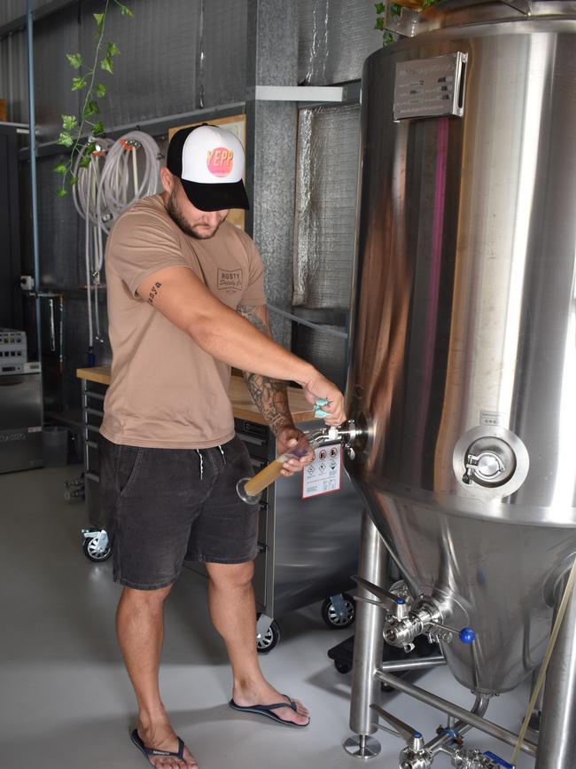 Justin Adams testing out the pilot beer at his new boutique brewery at Yeppoon.