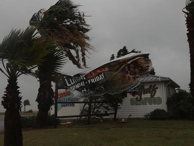 A sign blows in the wind after being partially torn from its frame in Corpus Christi, Texas. Picture: Joe Raedle/Getty Images/AFP