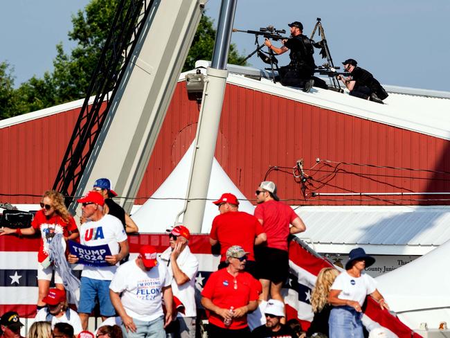 Law enforcement agents and members of the audience react after several pops the sounded like gunshots at a campaign rally for former President Donald Trump in Butler, Pennsylvania. Picture: New York Times/Headpress