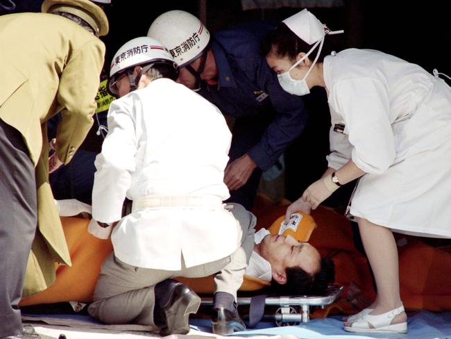 A commuter is treated by an emergency medical team after the Tokyo subway attack.