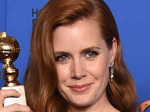 Amy Adams poses in the press room with the award for best actress in a motion picture - musical or comedy for “Big Eyes” at the 72nd annual Golden Globe Awards at the Beverly Hilton Hotel on Sunday, Jan. 11, 2015, in Beverly Hills, Calif. (Photo by Jordan Strauss/Invision/AP)