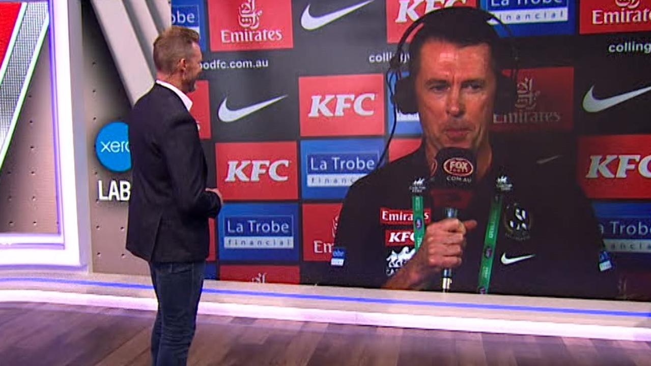 Collingwood coach Craig McRae chats to his predecessor Nathan Buckley pre-game.