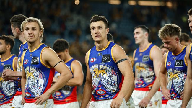 Hugh McCluggage (centre) and his dejected Brisbane teammates reflect on their loss to Hawthorn. Picture: Dylan Burns/AFL Photos via Getty Images
