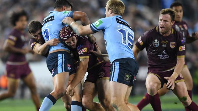 Kalyn Ponga showing some steel in defence in what was an auspicious debut. (AAP Image/David Moir)