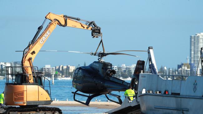 Authorities worked quickly on Tuesday morning to recover the helicopters before the tide rose. Picture: NCA Newswire/Scott Powick