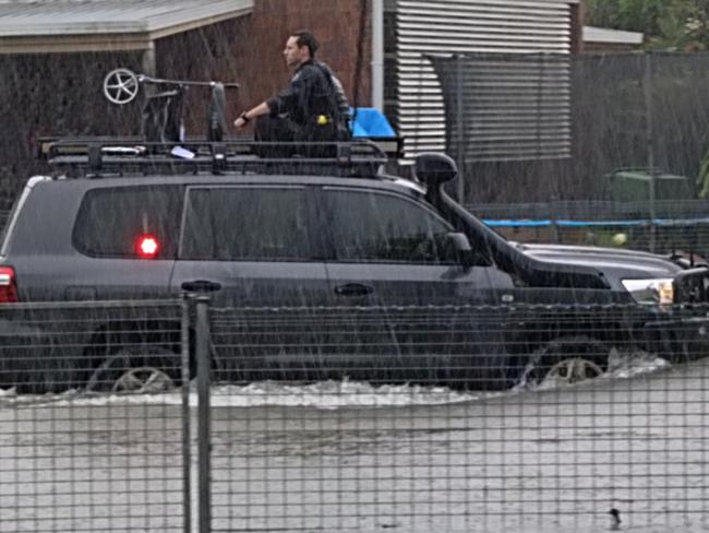 Queensland police officers rescued an elderley resident and their wheelie walker in a police four wheel drive after heavy rain caused flooding in Campbell Street, Klarwein Close and Whittaker Close in Gordonvale. Picture: Jade Fourmile