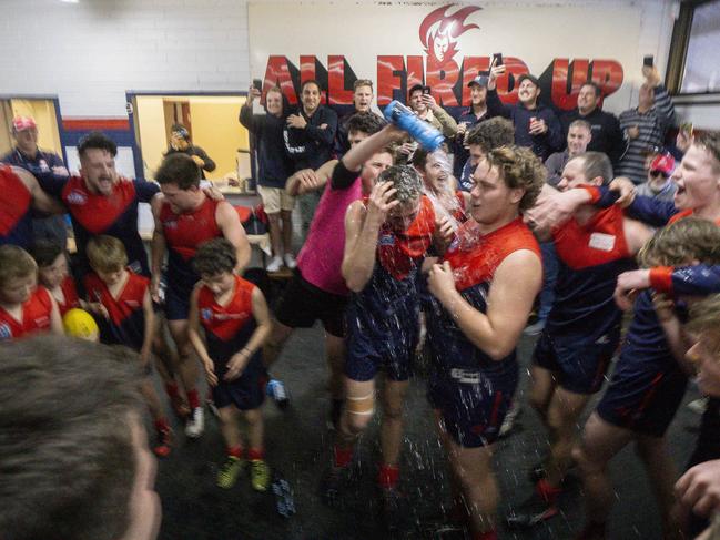 Bentleigh first-gamers Declan O’Brien-Reeve and Sam Ruddy get a celebratory spray as the Demons sing the song after their stunning win. Pic: Valeriu Campan.