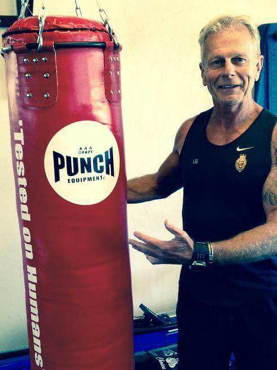 Lee Bowman with a punching bag.