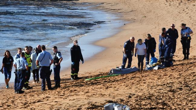 Emergency services at Mona Vale Beach after a woman was pulled from the water unconscious. Picture: Seb Dekker