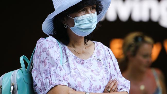 SYDNEY, AUSTRALIA - Newswire Photos JANUARY 03, 2022: A woman is seen wearing a face mask as she stops to watch the performer entertain the crowds shopping in Pitt Street Mall in the CBD in Sydney as Covid continues with very few people seen wearing face masks. Picture: NCA Newswire / Gaye Gerard