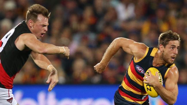 On the run ... Richard Douglas sprints away from Essendon’s Brendon Goddard. Picture: James Elsby (AFL Media/Getty Images)