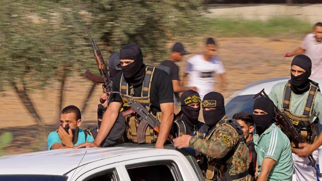 Palestinian militants move towards the border fence with Israel from Khan Yunis in the southern Gaza Strip on October 7.